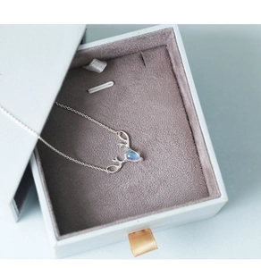 Silver reindeer antler necklace with blue moonstone pendant in a light blue jewelry box