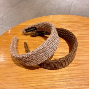 Chic knitted wide headband in beige and coffee colors featuring handmade craft texture