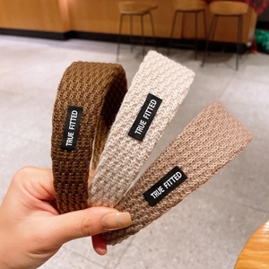 Knitted wide headband for women in retro coffee and beige colors with textured woven design