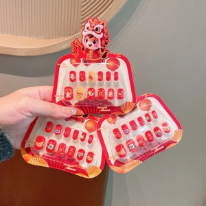 Detail of red festive reusable press-on nails for kids with cute lion dance design