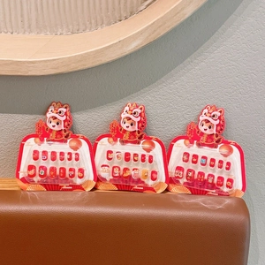 Three packs of reusable kids press-on nails featuring cute Chinese New Year lion dance motifs