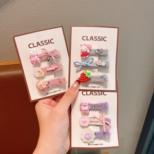 Detail of embroidered floral and animal hair clips for girls in a three-piece set