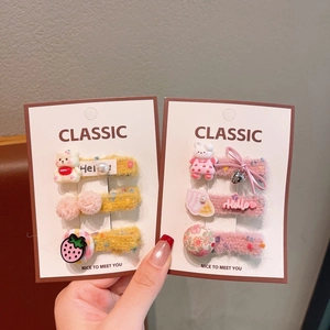 Close-up of cute floral embroidered hair clips with animal charms for girls