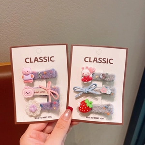 Detailed close-up of cute floral embroidered hair clips and resin charms for girls