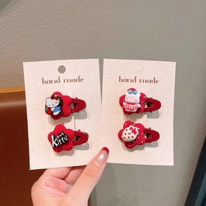 Detail of red floral hair clips set featuring Hello Kitty, bear and strawberry motifs