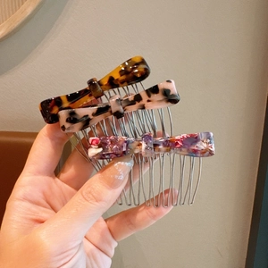 Detail view of acetate leopard bow hair combs with silver metal teeth in three colors