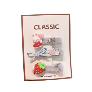 3-piece kids floral hair clip set featuring bunny strawberry and bow on display card