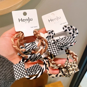 Elastic hair bands set with checkerboard, zebra, and leopard pattern fabric labels