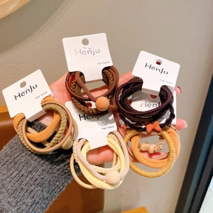 Set of high elasticity hair ties in earth tones with stylish round beads and bow details