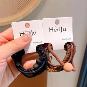 Close-up of high elasticity hair ties in black and coffee brown on a display card