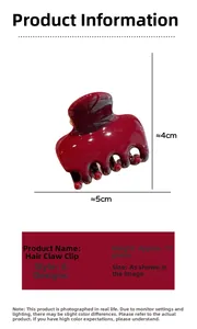 Macro detail of glossy wine red acrylic hair claw clip showing size and polished finish