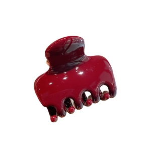 Glossy burgundy medium hair claw clip for women featuring a sleek resin finish design