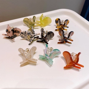 Macro shot of colorful acetate butterfly hair clips with diverse marble and tortoiseshell patterns