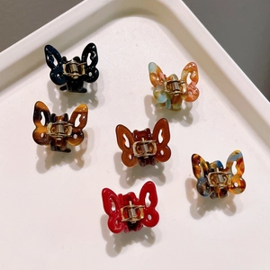Mini butterfly acetate hair clips in six colors including black red and tortoise pattern