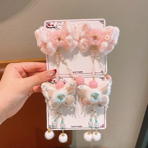 Winter floral butterfly hair clips for girls with pink tassels and white fur pom-poms
