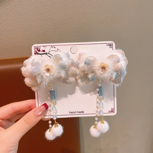 Detail of winter Hanfu hair clip featuring white faux fur with embroidery and pearl tassels