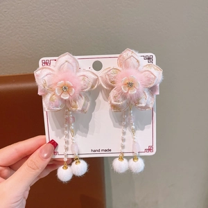Detail of pink floral Hanfu hair clips with hanging pearl tassels and soft white pom-poms