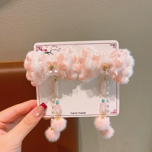 Detailed handmade pink Hanfu hair clip with floral embroidery, fur trim, and long tassels