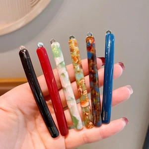 Detail showing various colors of French handmade hair clips with acetate finish and metal clasp