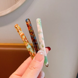 Three French style handmade acetate hair clips with marble and tortoise shell patterns