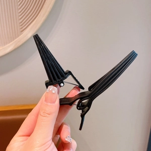 Handheld black alligator hair clip for root volume and professional hairstyling