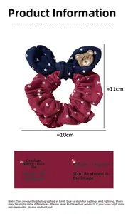 Detail view of burgundy fabric scrunchie with stars, bow, and bear charm, 10x11cm size