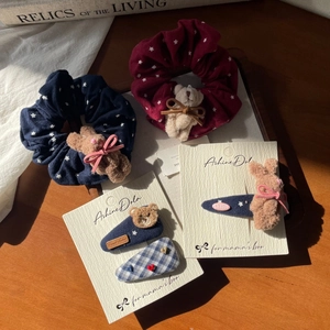 Detailed set of cute plush bear hair ties and checkered heart clips on display cards