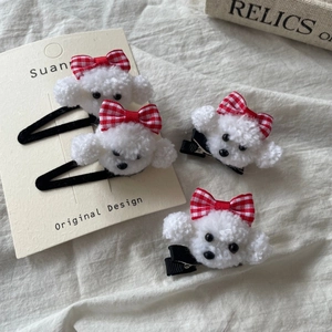 Cute white plush puppy hair clip with red checkered bow on aesthetic beige background