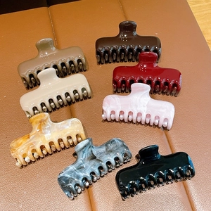 Variety set of eight acrylic claw clips in solid colors and marble patterns
