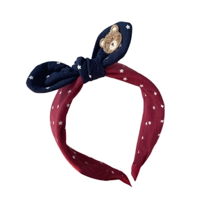 Pink and navy blue bow headband with teddy bear patch and white star patterns for girls
