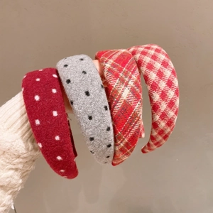 Set of four stylish wide plaid and polka dot wool headbands for women shown in hand