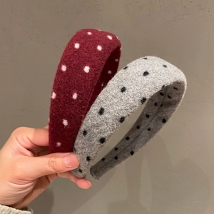 Close-up of thick red polka dot wool headband with elegant padded retro texture