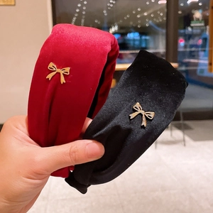 Elegant velvet headbands in black and burgundy with metallic bow accents for women