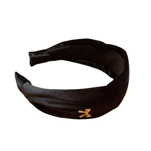 Elegant wide black velvet headband with gold metal bow accent for women's vintage style
