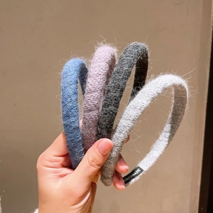 Close-up of soft knit headbands with handmade labels in four seasonal plush colors