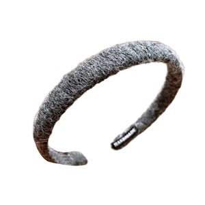 Deep grey knit headband with plush texture and handmade label on white background