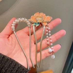 Detail of elegant Chinese hair pins with enamel floral petals and pearl tassels