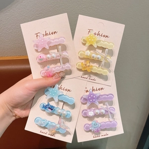 Detail view of octopus and star hair clips with glitter finish and pastel resin colors