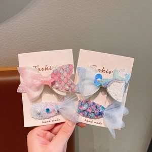 Detail of princess mermaid hair clips with mesh sequins, pearls and shell accents