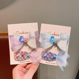 Detailed view of mermaid-themed hair clips with sequins, mesh bows and faux pearls