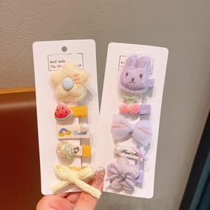 Close-up of colorful handmade flower and animal hair clips for girls' hair styling