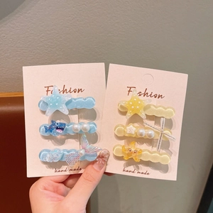 Detail of octopus and starfish hair clips on display cards in jelly colors