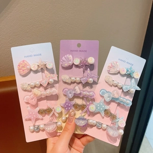 Set de barrettes étincelantes avec coquillages, perles, étoiles et nœuds pour filles