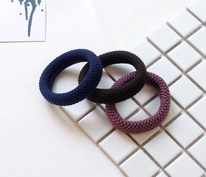 Detailed view of high-elasticity hair bands in navy blue, brown and purple knitted fabric