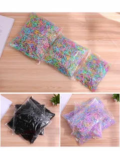 Detail view of colorful and black disposable elastic hair bands in clear packaging bags