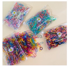 Detail of multi-colored high-elastic kids rubber bands in a daisy logo zipper bag
