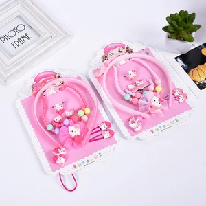 Detail view of pink Hello Kitty hair accessories set including headband and necklace
