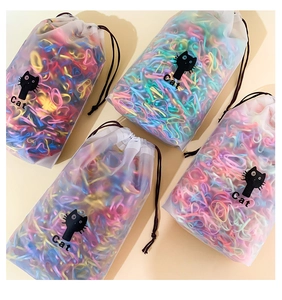 Macro detail of colorful children's hair bands in cute cat frosted drawstring bags