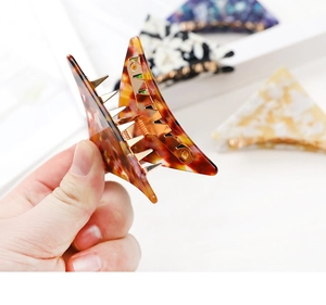 Large acetate triangular hair claw clips in various stylish marble patterns and colors