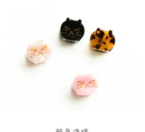 Detailed view of mini acetate cat hair claws in black, tortoiseshell, and pink colors